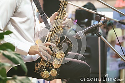 Musicians are using saxophone for live music. Stock Photo