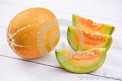 Muskmelon sliced cantaloupe thai tropical fruit asian on wood background - melon yellow Stock Photo