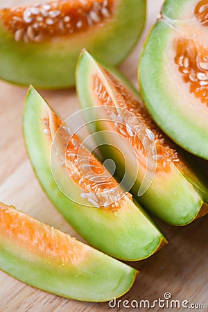 Muskmelon sliced cantaloupe thai tropical fruit asian on wood background - melon yellow Stock Photo