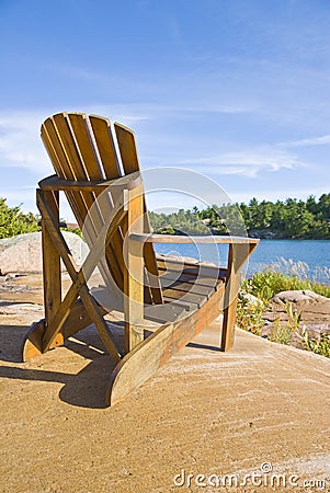 Muskoka Chair On a Big Rock Stock Photo