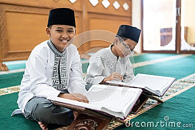 Muslim asian kid bestfriend reading quran Stock Photo