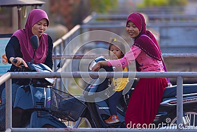Muslim Cambodian women on motorbikes at SIEM REAP city district Editorial Stock Photo