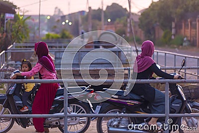 Muslim Cambodian women on motorbikes at SIEM REAP city district Editorial Stock Photo