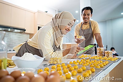 muslim couple business seller making food order at home together. Stock Photo