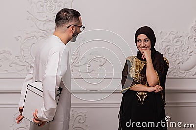 Muslim couple, a man makes a gift to his woman. Surprise from husband to wife Stock Photo