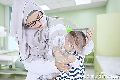 Muslim doctor examining a baby Stock Photo