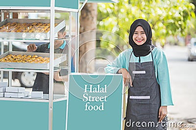 Muslim entrepreneur with food stall Stock Photo