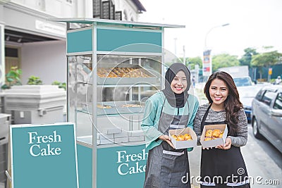 Muslim entrepreneur with partner starting food stall business Stock Photo