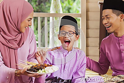 Muslim family feasting during the Eid celebration Stock Photo