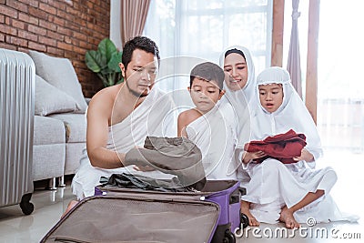 Muslim family packing for umrah and hajj Stock Photo