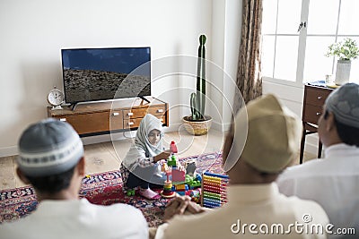 Muslim family relaxing and playing at home Stock Photo