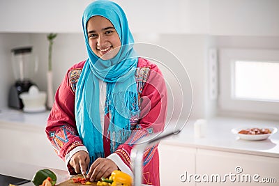 Muslim girl In kitchen Stock Photo