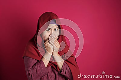 Muslim lady close her mouth, worried nervous gesture Stock Photo
