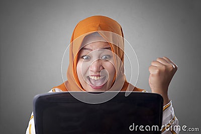 Muslim Lady Shows Winning Gesture, Receiving Good News on Her Email Stock Photo