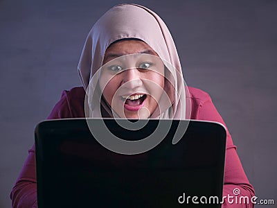 Muslim Lady Shows Winning Gesture, Receiving Good News on Her Email Stock Photo