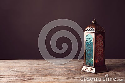 Muslim lamp with candle on wooden table Stock Photo