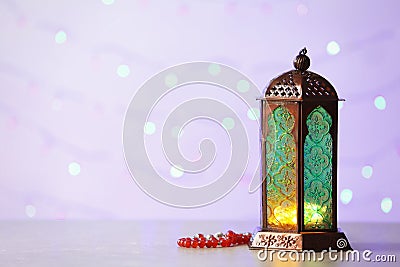 Muslim lamp Fanus with prayer beads and space for design Stock Photo