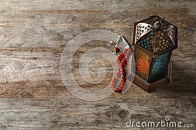 Muslim lamp and misbaha on wooden background Stock Photo
