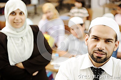 Muslim male and female teachers in classroom Stock Photo