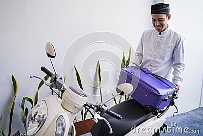 Muslim male travelling for eid mubarak lebaran by motorcyle Stock Photo