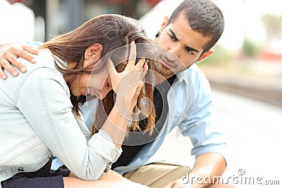Muslim man comforting a sad girl mourning Stock Photo