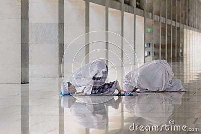 Muslim man with his wife doing Salat together Stock Photo