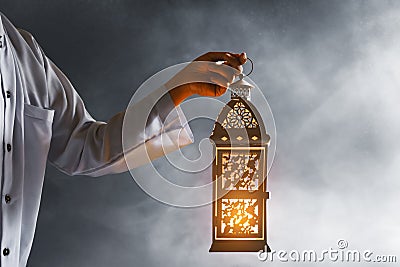 Muslim man hold arabic lantern, Ramadan kareem background Stock Photo