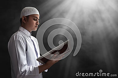 Muslim man reading koran Stock Photo