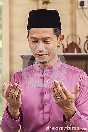 Muslim man saying prayers Stock Photo