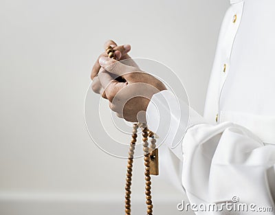Muslim man using misbaha to keep track of counting in tasbih Stock Photo
