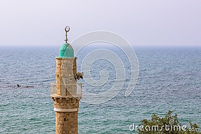 Muslim minaret tower Eastern religion architecture building moody weather Bosporus strait sea waters horizon landscape background Stock Photo