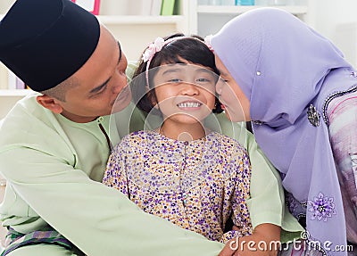 Muslim Parents Kissing Child. Stock Photography - Image 