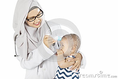 Muslim pediatrician checking her patient Stock Photo