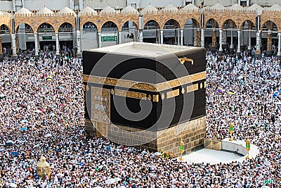 Muslim pilgrims revolving around the Kaaba in Mecca Saudi Arabia. Muslim people praying together at holy place. Editorial Stock Photo