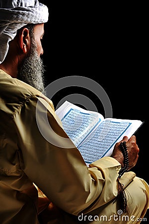 Muslim reading Koran Stock Photo