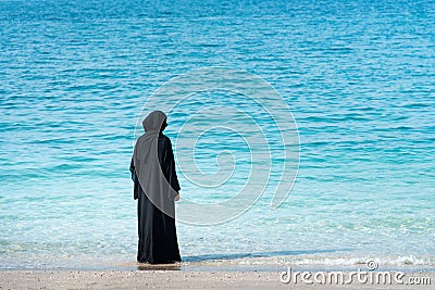 Muslim woman in abaya by the seaside Stock Photo