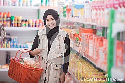 Muslim woman buying some halal product Stock Photo