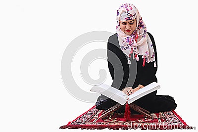 Muslim woman in hijab reading quaran holy book Stock Photo