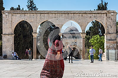 Muslim woman walking out of the square of the Golden Dome of the Rock Editorial Stock Photo