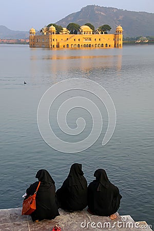 Muslim women sitting on the shore of Man Sagar Lake in Jaipur Editorial Stock Photo