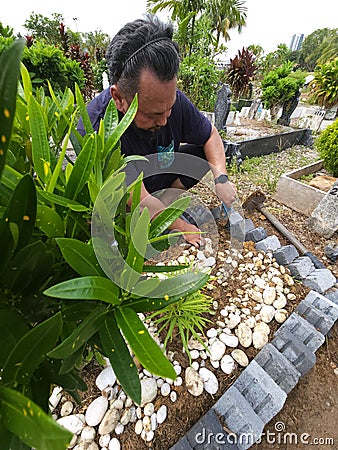 Muslims grave maintenance by the family. Stock Photo