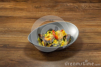 Mussel Prawn Soupy Rice served in a dish top view on dark wooden background Stock Photo
