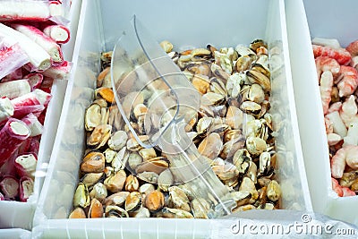 Mussels in fridges with seafood in the supermarket. Stock Photo