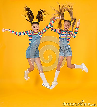 Must have accessory. Modern fashion. Kids fashion. Little girls wearing rainbow clothes. Happiness. Girls long hair Stock Photo