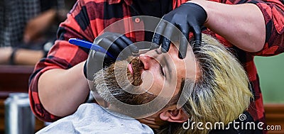 Must try. bearded man getting beard haircut by barber. moustache and beard. sitting in chair at hairdresser. mature man Stock Photo