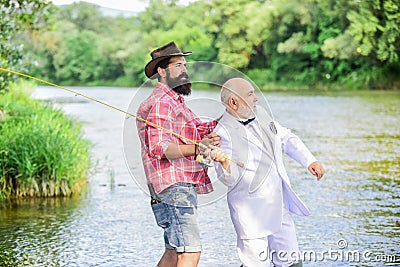He must use it. retired businessman. male friendship. family, granddad and drandson fishing. hobby and recreation. two Stock Photo