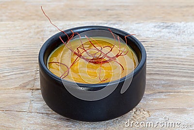 Mustard dip with chili threads macro on wood background Stock Photo