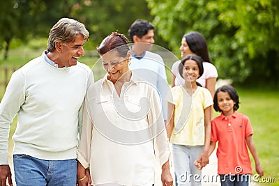 Muti-Generation Indian Family Walking In Countryside Stock Photo