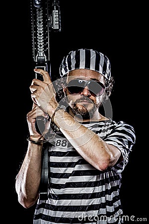 Mutiny, Prison riot concept. Man holding a machine gun, prisoner Stock Photo