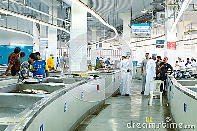 MUTRAH, OMAN - NOVEMBER 14, 2022: Vendors selling tuna, sardines and other fish species at fish souk in Mutrah. Oman. Editorial Stock Photo